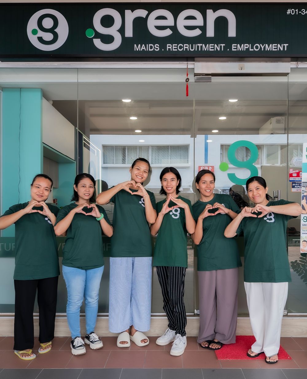 Helpers standing outside Green Employment maid agency office