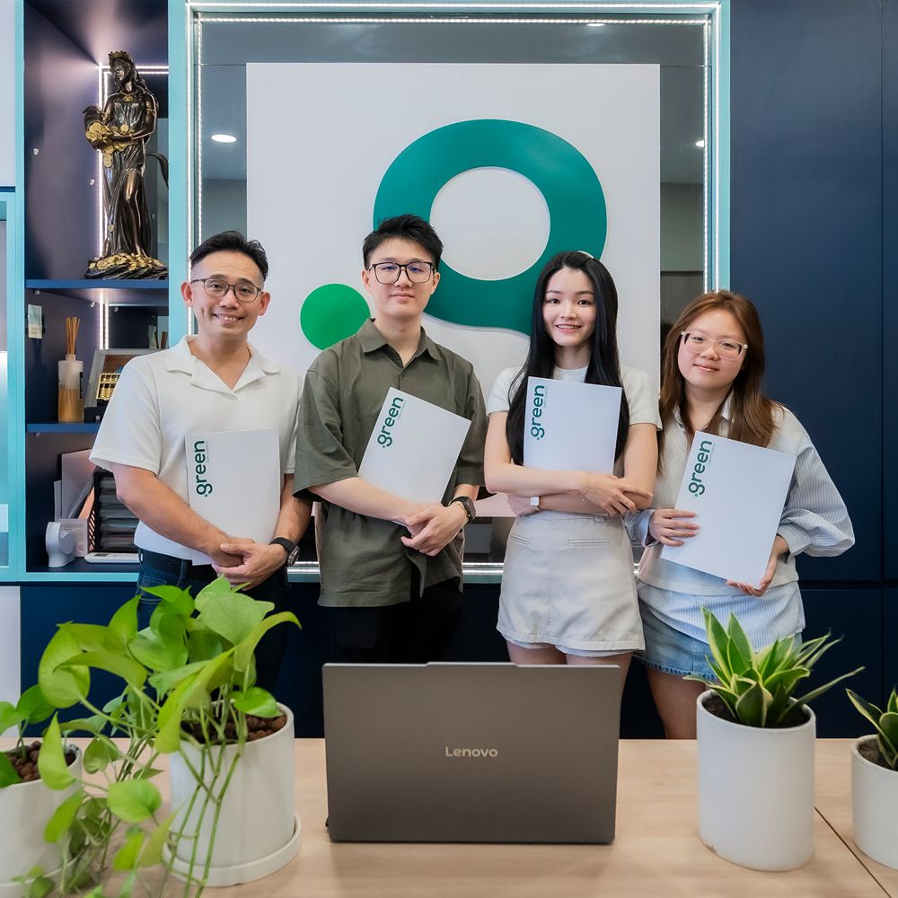 Green Employment team holding agency document in the office